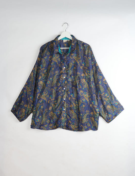 Experience chic comfort with our OVERSIZED SHIRT – a one-of-a-kind piece crafted from sari waste by talented Indian female artisans. With 3/4 length sleeves, a regular shirt collar, and a contrasting inner collar band, this shirt is perfect for work or casual hangouts. Versatile and stylish, it pairs effortlessly over a shift dress, jumpsuit, or with pants.