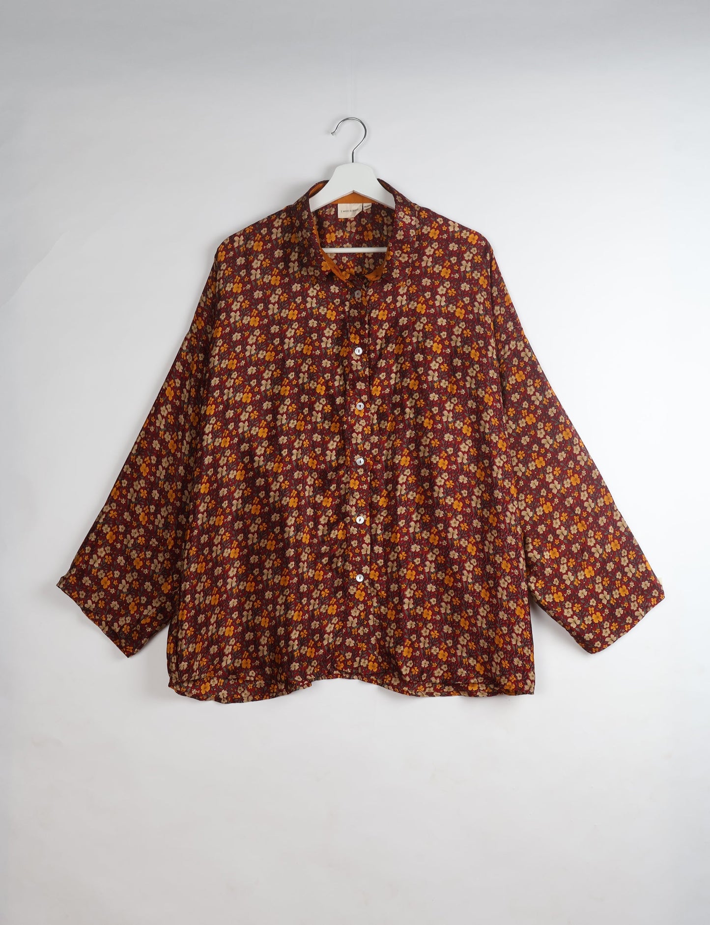 Experience chic comfort with our OVERSIZED SHIRT – a one-of-a-kind piece crafted from sari waste by talented Indian female artisans. With 3/4 length sleeves, a regular shirt collar, and a contrasting inner collar band, this shirt is perfect for work or casual hangouts. Versatile and stylish, it pairs effortlessly over a shift dress, jumpsuit, or with pants.