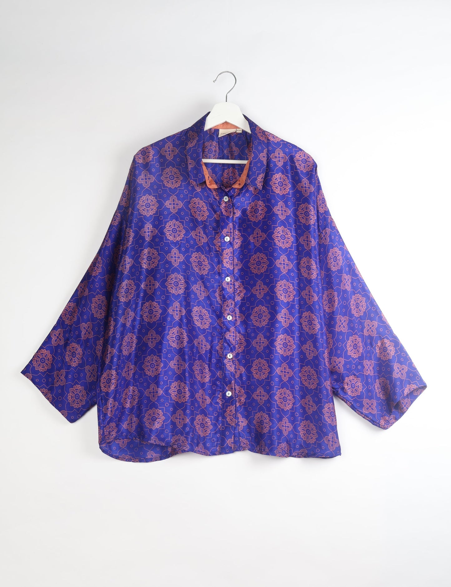 Experience chic comfort with our OVERSIZED SHIRT – a one-of-a-kind piece crafted from sari waste by talented Indian female artisans. With 3/4 length sleeves, a regular shirt collar, and a contrasting inner collar band, this shirt is perfect for work or casual hangouts. Versatile and stylish, it pairs effortlessly over a shift dress, jumpsuit, or with pants.