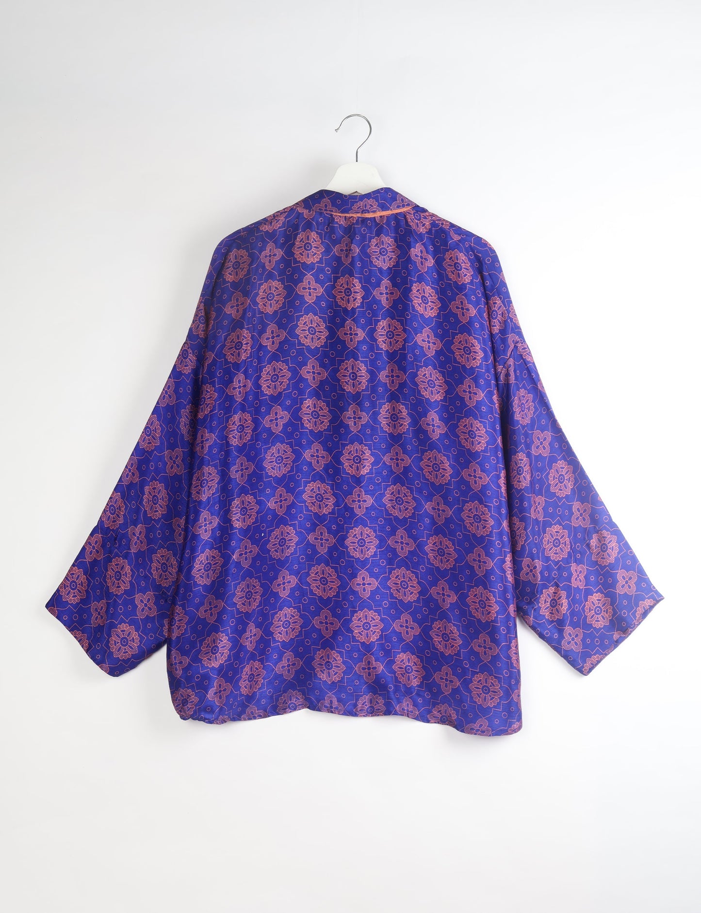 Experience chic comfort with our OVERSIZED SHIRT – a one-of-a-kind piece crafted from sari waste by talented Indian female artisans. With 3/4 length sleeves, a regular shirt collar, and a contrasting inner collar band, this shirt is perfect for work or casual hangouts. Versatile and stylish, it pairs effortlessly over a shift dress, jumpsuit, or with pants.