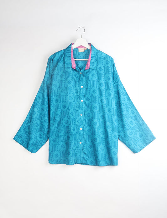 Experience chic comfort with our OVERSIZED SHIRT – a one-of-a-kind piece crafted from sari waste by talented Indian female artisans. With 3/4 length sleeves, a regular shirt collar, and a contrasting inner collar band, this shirt is perfect for work or casual hangouts. Versatile and stylish, it pairs effortlessly over a shift dress, jumpsuit, or with pants.