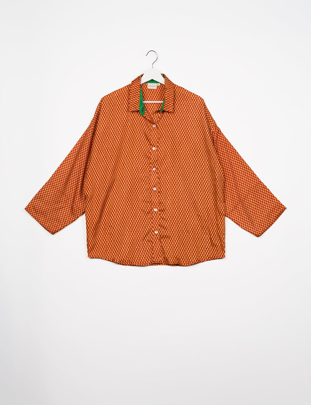 Experience chic comfort with our OVERSIZED SHIRT – a one-of-a-kind piece crafted from sari waste by talented Indian female artisans. With 3/4 length sleeves, a regular shirt collar, and a contrasting inner collar band, this shirt is perfect for work or casual hangouts. Versatile and stylish, it pairs effortlessly over a shift dress, jumpsuit, or with pants.