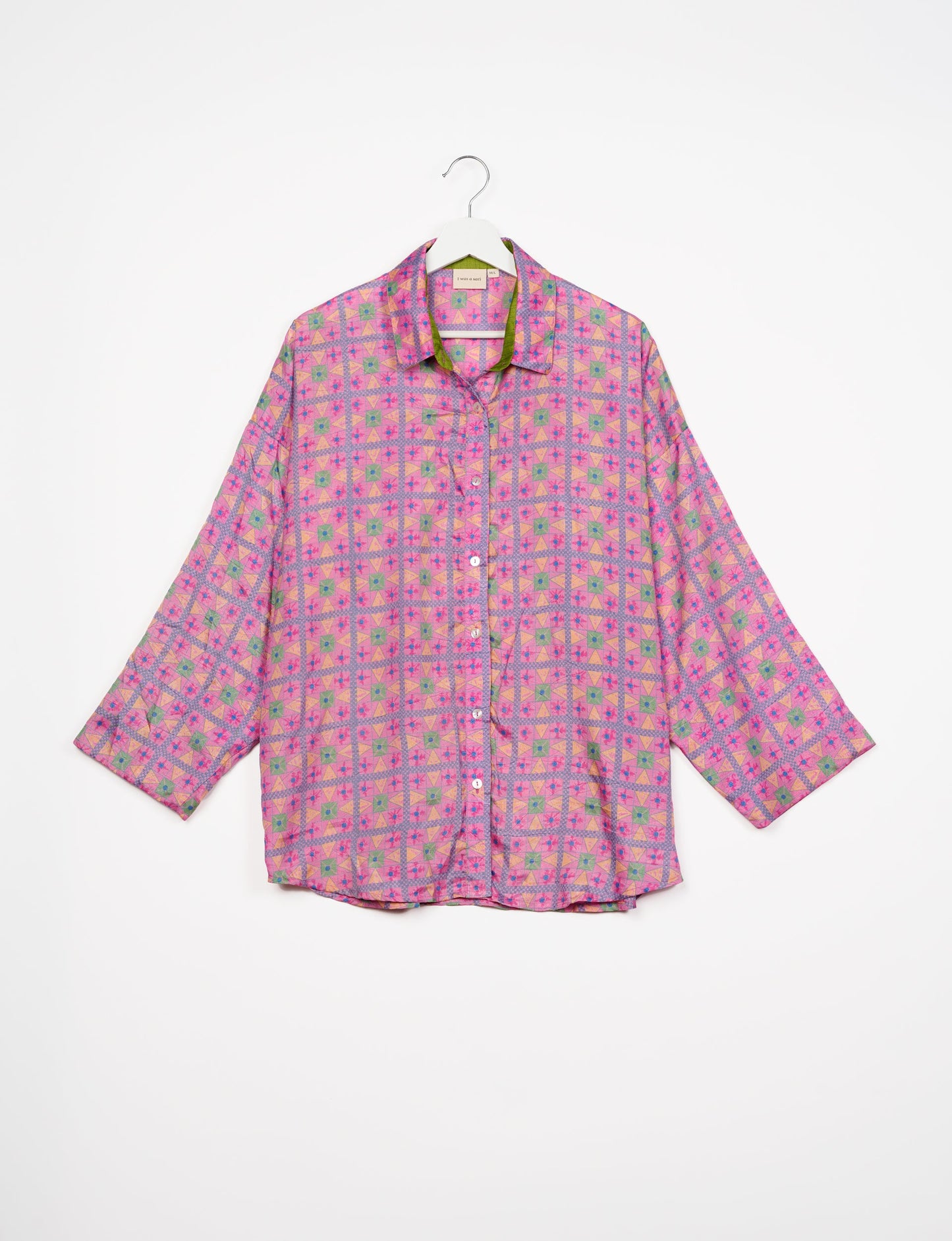 Experience chic comfort with our OVERSIZED SHIRT – a one-of-a-kind piece crafted from sari waste by talented Indian female artisans. With 3/4 length sleeves, a regular shirt collar, and a contrasting inner collar band, this shirt is perfect for work or casual hangouts. Versatile and stylish, it pairs effortlessly over a shift dress, jumpsuit, or with pants.