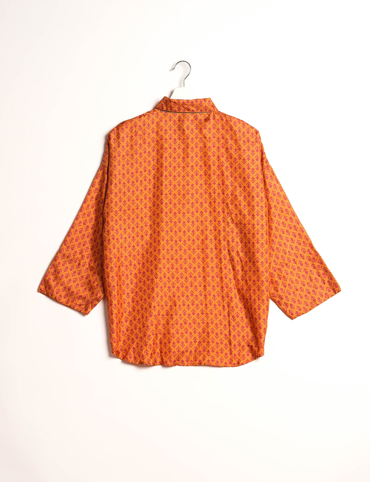 Experience chic comfort with our OVERSIZED SHIRT – a one-of-a-kind piece crafted from sari waste by talented Indian female artisans. With 3/4 length sleeves, a regular shirt collar, and a contrasting inner collar band, this shirt is perfect for work or casual hangouts. Versatile and stylish, it pairs effortlessly over a shift dress, jumpsuit, or with pants.