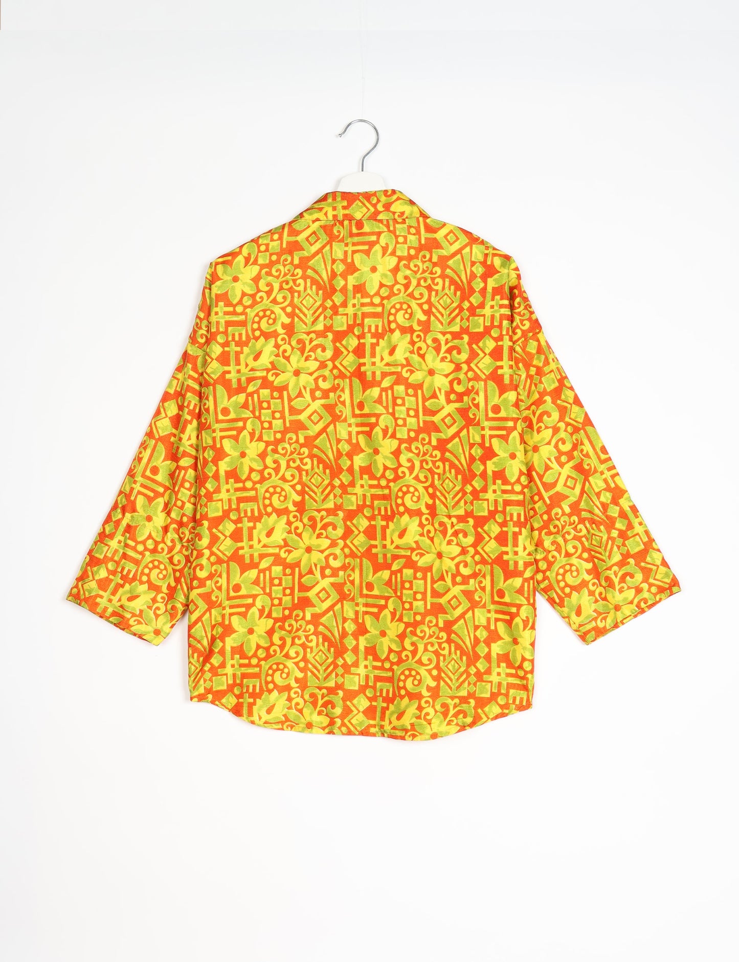 Experience chic comfort with our OVERSIZED SHIRT – a one-of-a-kind piece crafted from sari waste by talented Indian female artisans. With 3/4 length sleeves, a regular shirt collar, and a contrasting inner collar band, this shirt is perfect for work or casual hangouts. Versatile and stylish, it pairs effortlessly over a shift dress, jumpsuit, or with pants.