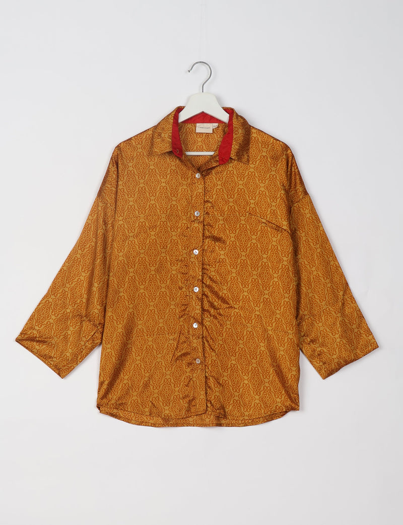 Yellow oversized shirt with Indian ethnic pattern, red inner collar, front buttons, and chest pocket, hanging on white hanger
