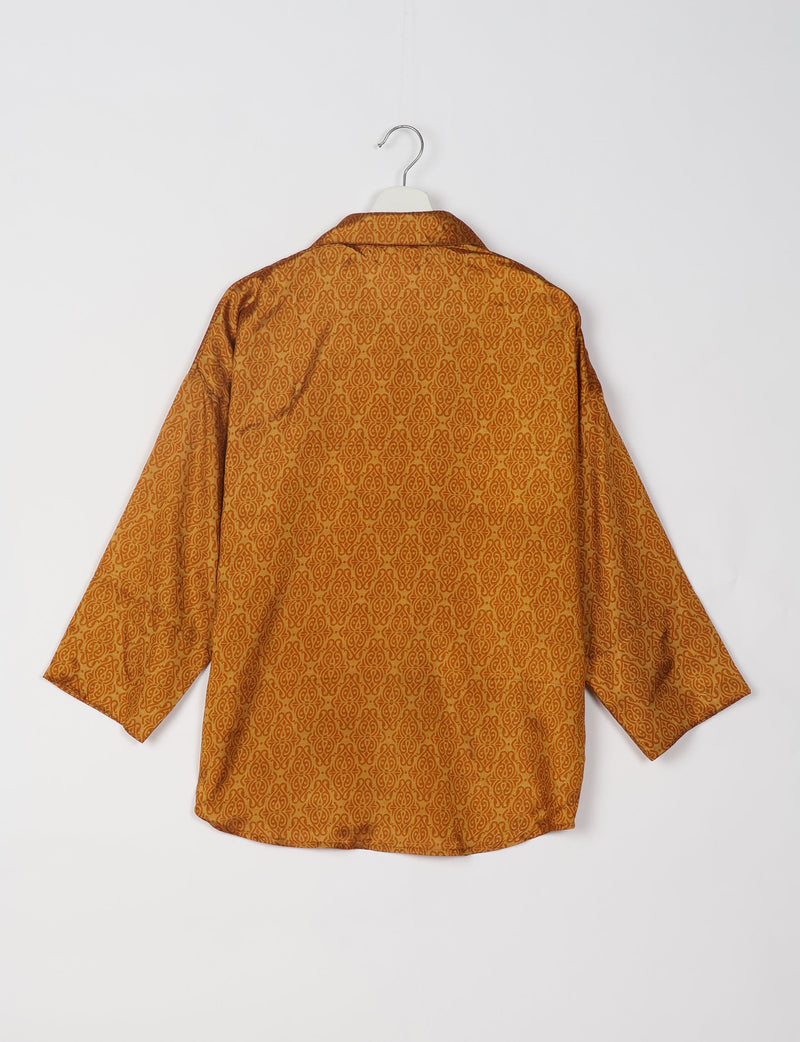 Yellow oversized shirt with Indian ethnic pattern, long sleeves, and spread collar, shown from back on hanger
