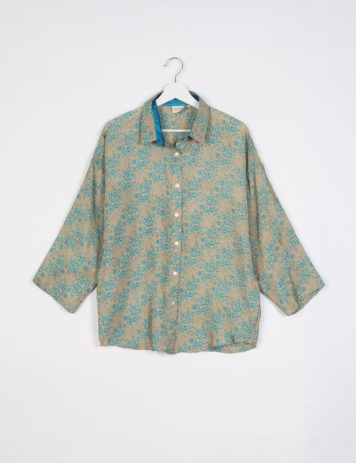 Experience chic comfort with our OVERSIZED SHIRT – a one-of-a-kind piece crafted from sari waste by talented Indian female artisans. With 3/4 length sleeves, a regular shirt collar, and a contrasting inner collar band, this shirt is perfect for work or casual hangouts. Versatile and stylish, it pairs effortlessly over a shift dress, jumpsuit, or with pants.