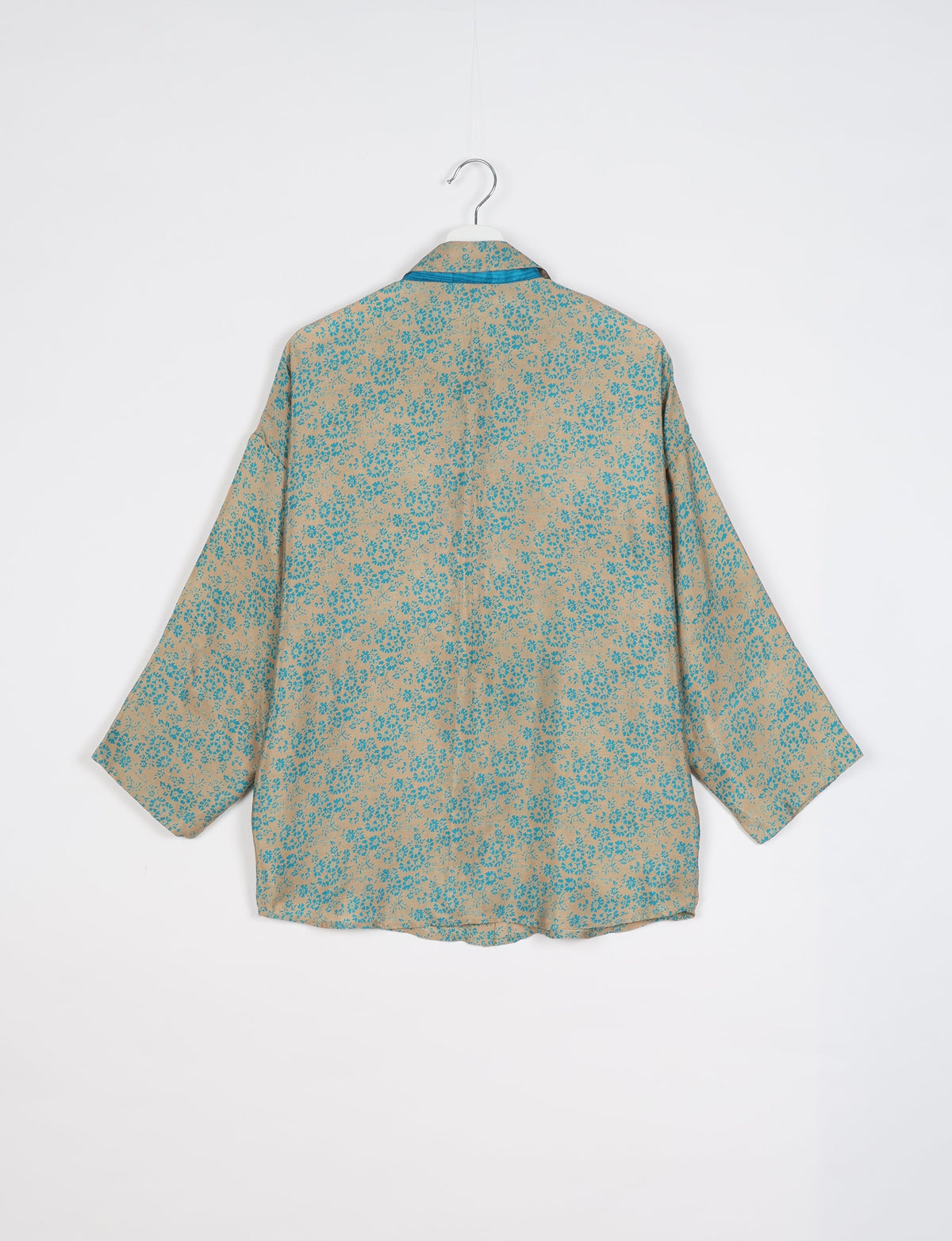 Experience chic comfort with our OVERSIZED SHIRT – a one-of-a-kind piece crafted from sari waste by talented Indian female artisans. With 3/4 length sleeves, a regular shirt collar, and a contrasting inner collar band, this shirt is perfect for work or casual hangouts. Versatile and stylish, it pairs effortlessly over a shift dress, jumpsuit, or with pants.
