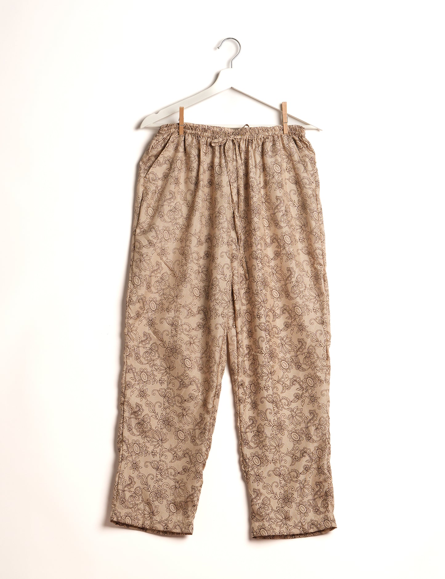 Elevate your wardrobe with our planet-friendly PULL-ON PANTS. Made from upcycled sari fabric, these eco-conscious pants offer a drawstring waist for a perfect fit. Tapered leg design ensures both style and comfort. Choose ethical, green fashion that supports artisans and sustainable living.