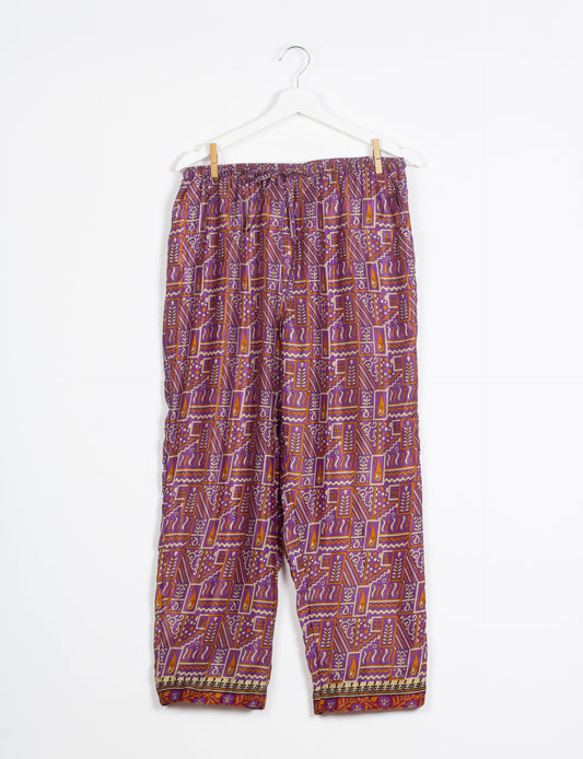 Elevate your wardrobe with our planet-friendly PULL-ON PANTS. Made from upcycled sari fabric, these eco-conscious pants offer a drawstring waist for a perfect fit. Tapered leg design ensures both style and comfort. Choose ethical, green fashion that supports artisans and sustainable living.