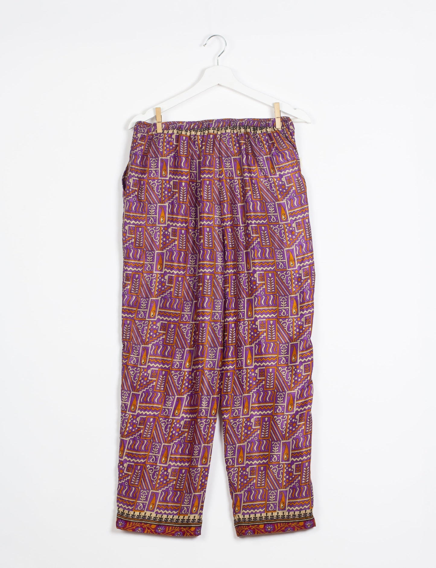 Elevate your wardrobe with our planet-friendly PULL-ON PANTS. Made from upcycled sari fabric, these eco-conscious pants offer a drawstring waist for a perfect fit. Tapered leg design ensures both style and comfort. Choose ethical, green fashion that supports artisans and sustainable living.