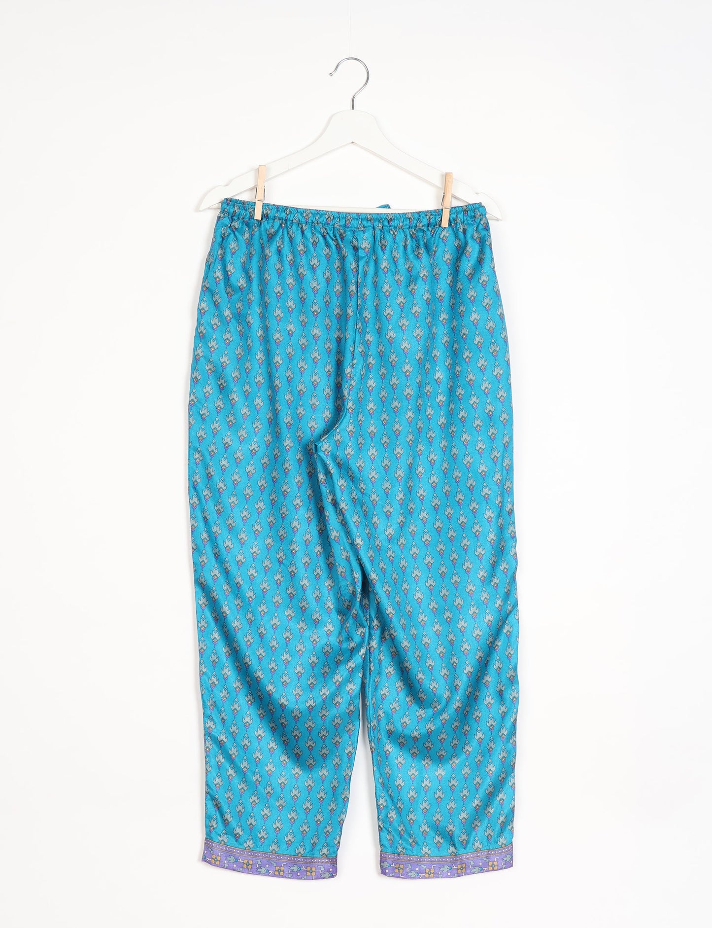 Elevate your wardrobe with our planet-friendly PULL-ON PANTS. Made from upcycled sari fabric, these eco-conscious pants offer a drawstring waist for a perfect fit. Tapered leg design ensures both style and comfort. Choose ethical, green fashion that supports artisans and sustainable living.