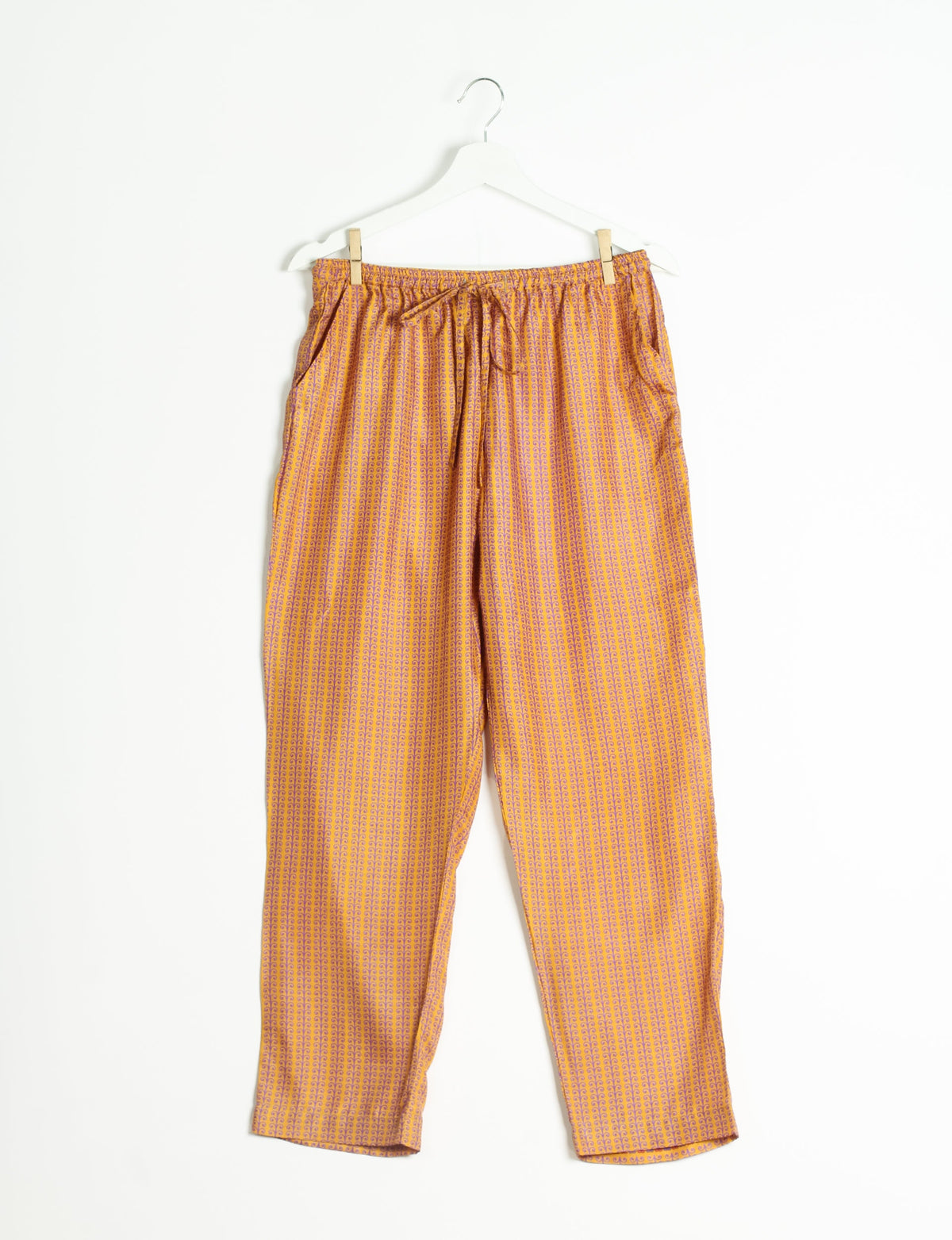 Elevate your wardrobe with our planet-friendly PULL-ON PANTS. Made from upcycled sari fabric, these eco-conscious pants offer a drawstring waist for a perfect fit. Tapered leg design ensures both style and comfort. Choose ethical, green fashion that supports artisans and sustainable living.