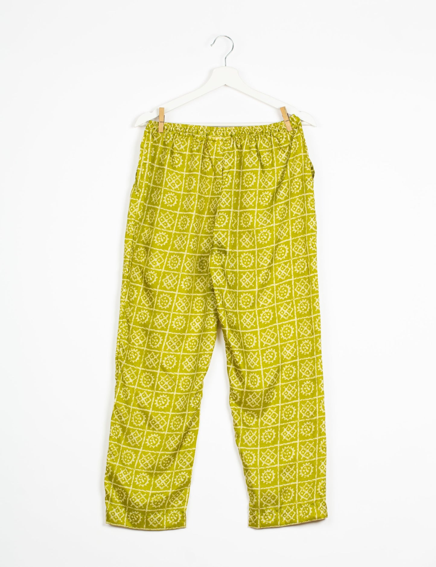 Elevate your wardrobe with our planet-friendly PULL-ON PANTS. Made from upcycled sari fabric, these eco-conscious pants offer a drawstring waist for a perfect fit. Tapered leg design ensures both style and comfort. Choose ethical, green fashion that supports artisans and sustainable living.