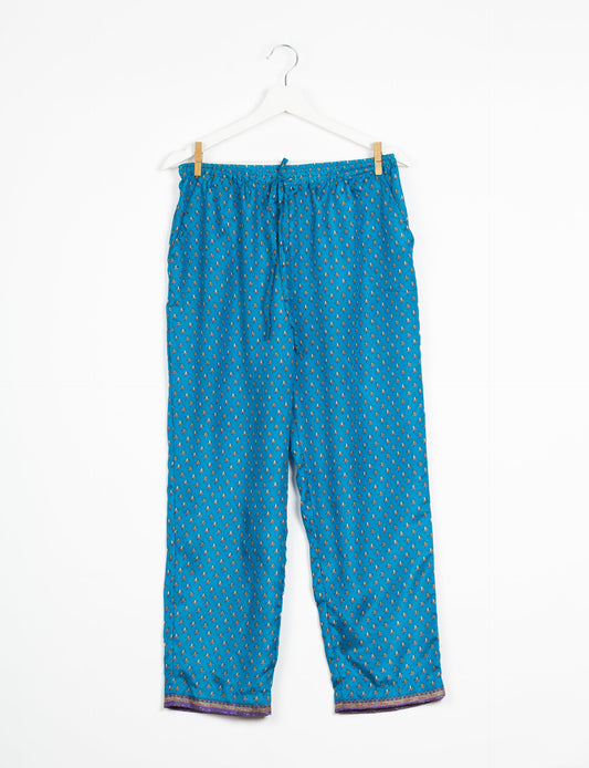 Elevate your wardrobe with our planet-friendly PULL-ON PANTS. Made from upcycled sari fabric, these eco-conscious pants offer a drawstring waist for a perfect fit. Tapered leg design ensures both style and comfort. Choose ethical, green fashion that supports artisans and sustainable living.