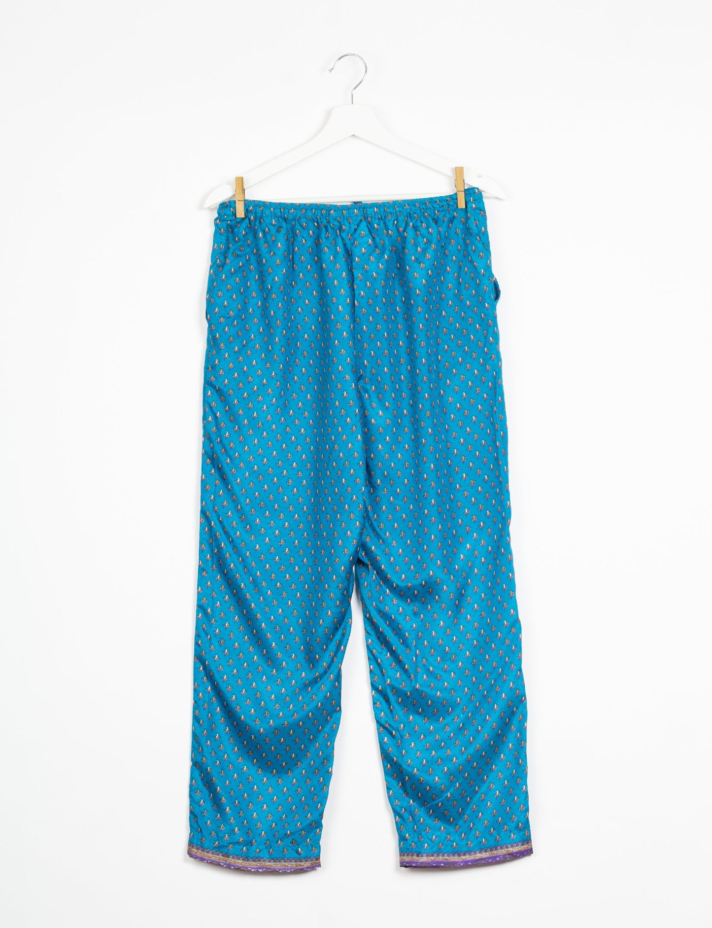 Elevate your wardrobe with our planet-friendly PULL-ON PANTS. Made from upcycled sari fabric, these eco-conscious pants offer a drawstring waist for a perfect fit. Tapered leg design ensures both style and comfort. Choose ethical, green fashion that supports artisans and sustainable living.