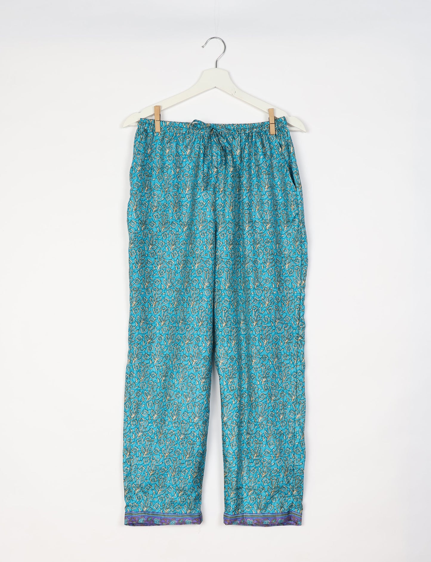 Elevate your wardrobe with our planet-friendly PULL-ON PANTS. Made from upcycled sari fabric, these eco-conscious pants offer a drawstring waist for a perfect fit. Tapered leg design ensures both style and comfort. Choose ethical, green fashion that supports artisans and sustainable living.