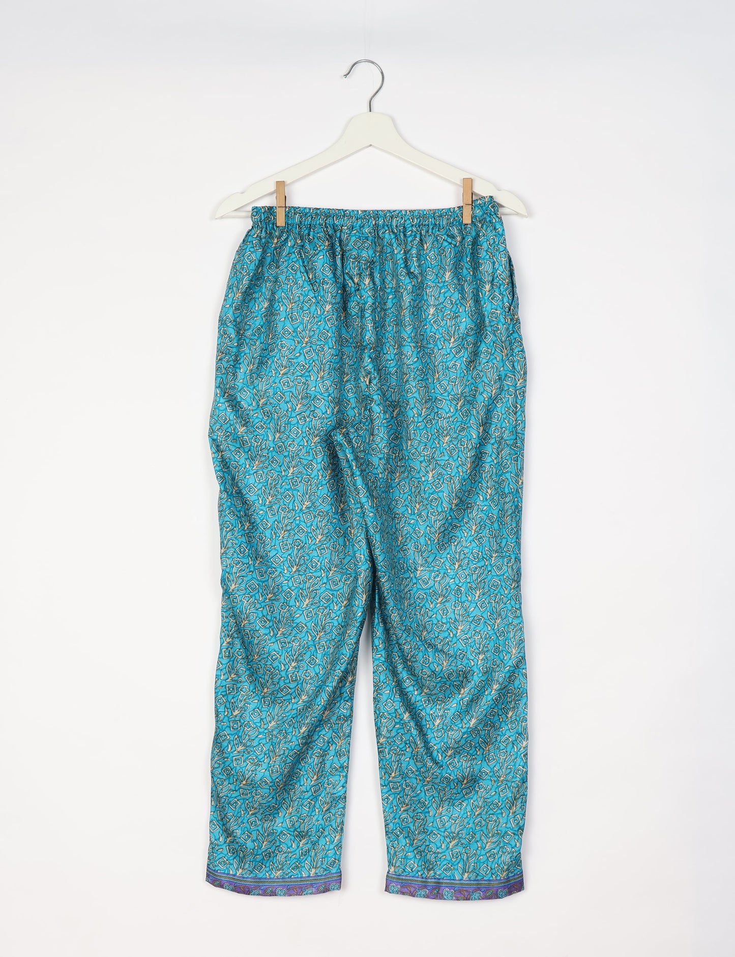Elevate your wardrobe with our planet-friendly PULL-ON PANTS. Made from upcycled sari fabric, these eco-conscious pants offer a drawstring waist for a perfect fit. Tapered leg design ensures both style and comfort. Choose ethical, green fashion that supports artisans and sustainable living.