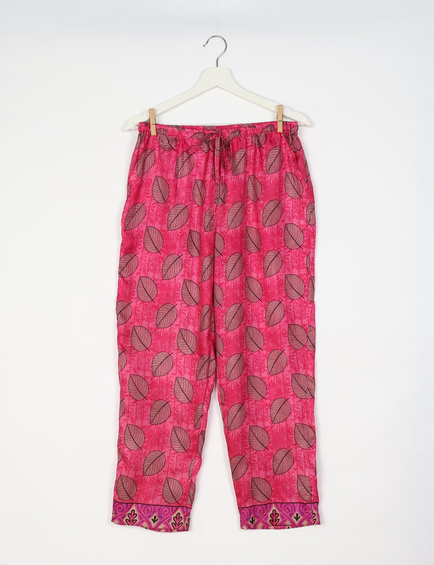 Elevate your wardrobe with our planet-friendly PULL-ON PANTS. Made from upcycled sari fabric, these eco-conscious pants offer a drawstring waist for a perfect fit. Tapered leg design ensures both style and comfort. Choose ethical, green fashion that supports artisans and sustainable living.