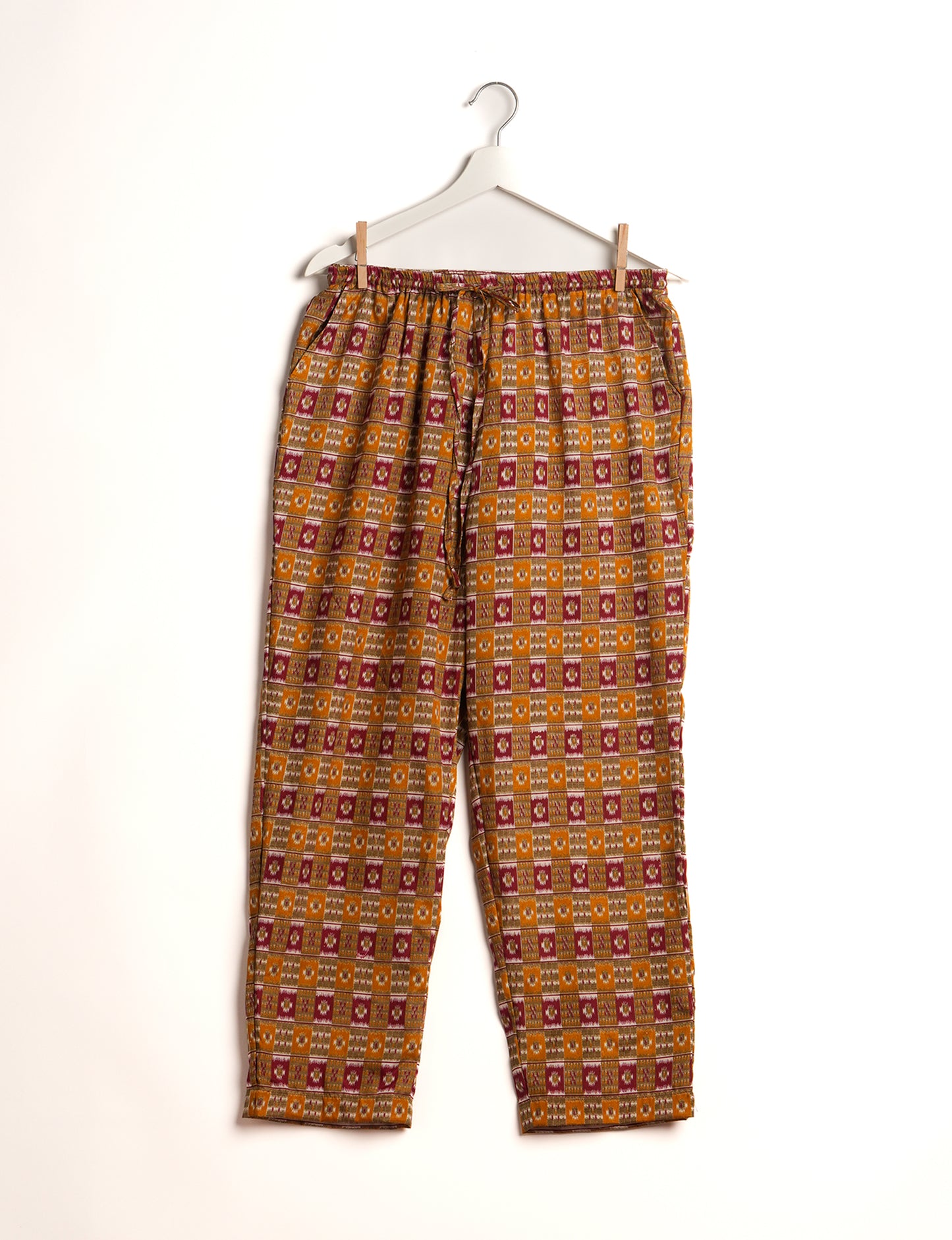 Elevate your wardrobe with our planet-friendly PULL-ON PANTS. Made from upcycled sari fabric, these eco-conscious pants offer a drawstring waist for a perfect fit. Tapered leg design ensures both style and comfort. Choose ethical, green fashion that supports artisans and sustainable living.