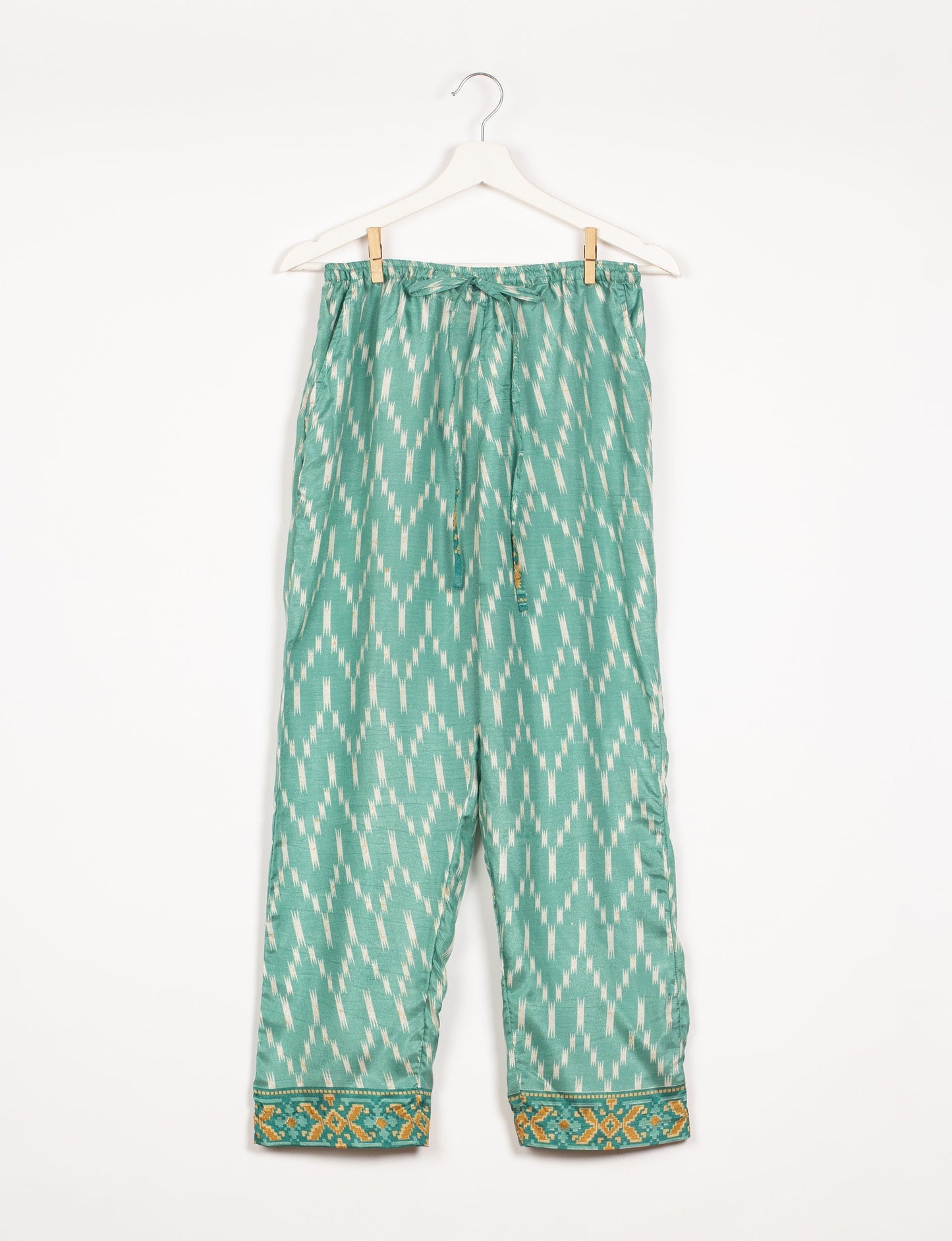 Elevate your wardrobe with our planet-friendly PULL-ON PANTS. Made from upcycled sari fabric, these eco-conscious pants offer a drawstring waist for a perfect fit. Tapered leg design ensures both style and comfort. Choose ethical, green fashion that supports artisans and sustainable living.