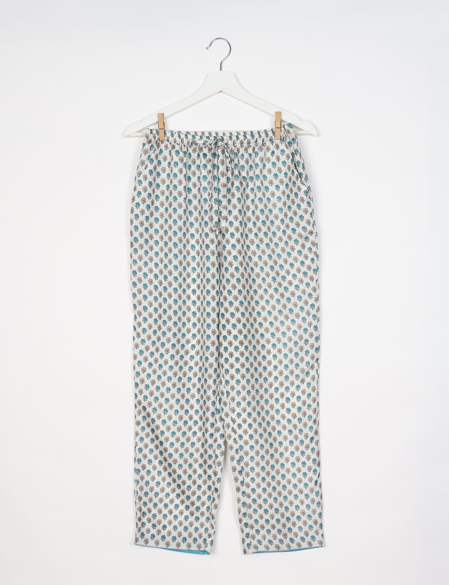 Elevate your wardrobe with our planet-friendly PULL-ON PANTS. Made from upcycled sari fabric, these eco-conscious pants offer a drawstring waist for a perfect fit. Tapered leg design ensures both style and comfort. Choose ethical, green fashion that supports artisans and sustainable living.