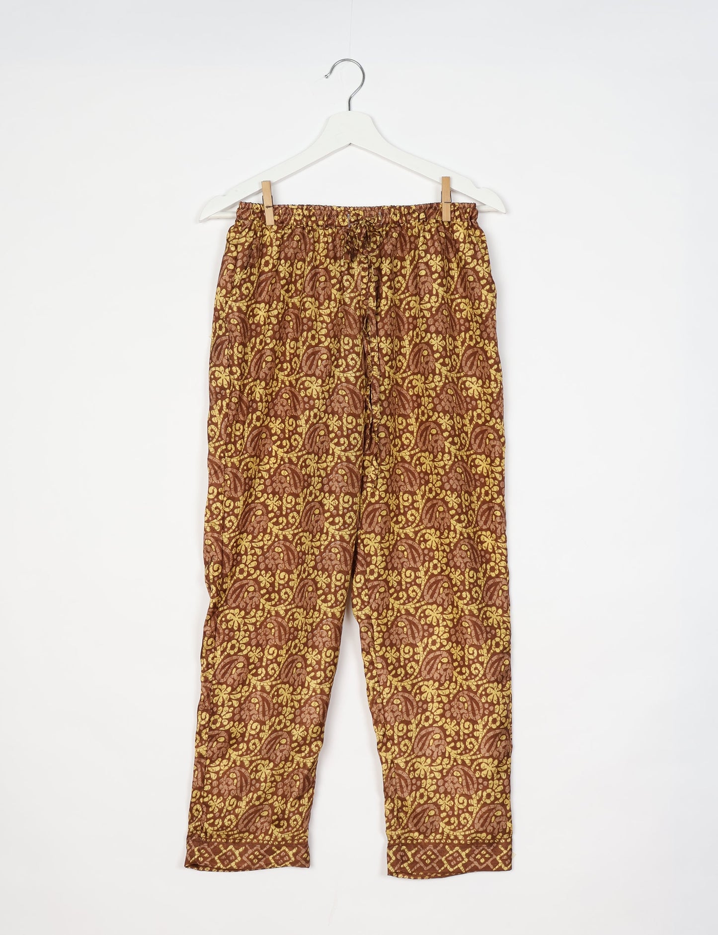 Elevate your wardrobe with our planet-friendly PULL-ON PANTS. Made from upcycled sari fabric, these eco-conscious pants offer a drawstring waist for a perfect fit. Tapered leg design ensures both style and comfort. Choose ethical, green fashion that supports artisans and sustainable living.