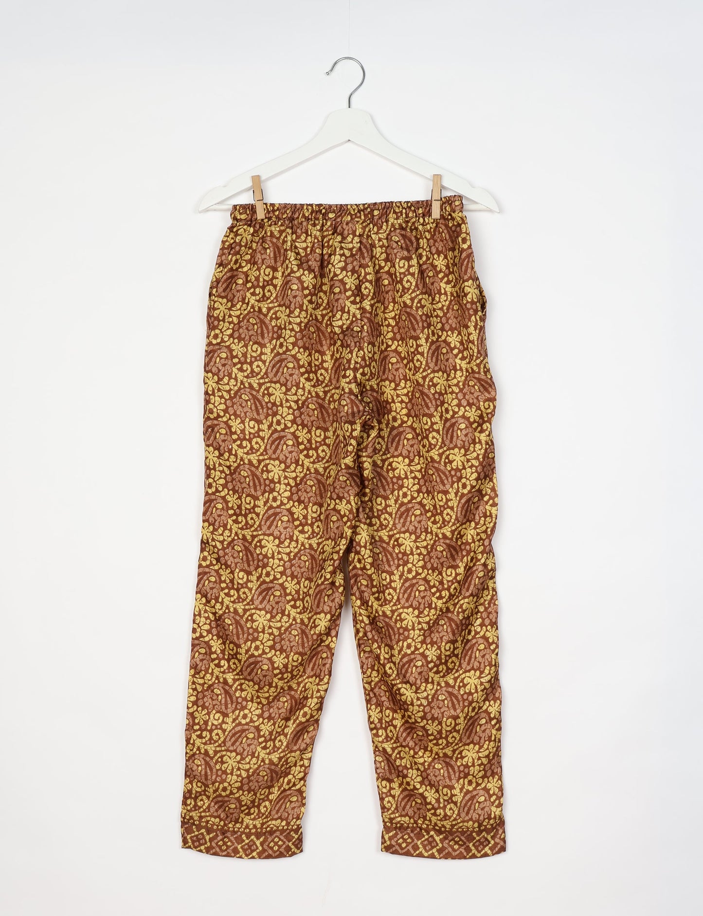 Elevate your wardrobe with our planet-friendly PULL-ON PANTS. Made from upcycled sari fabric, these eco-conscious pants offer a drawstring waist for a perfect fit. Tapered leg design ensures both style and comfort. Choose ethical, green fashion that supports artisans and sustainable living.
