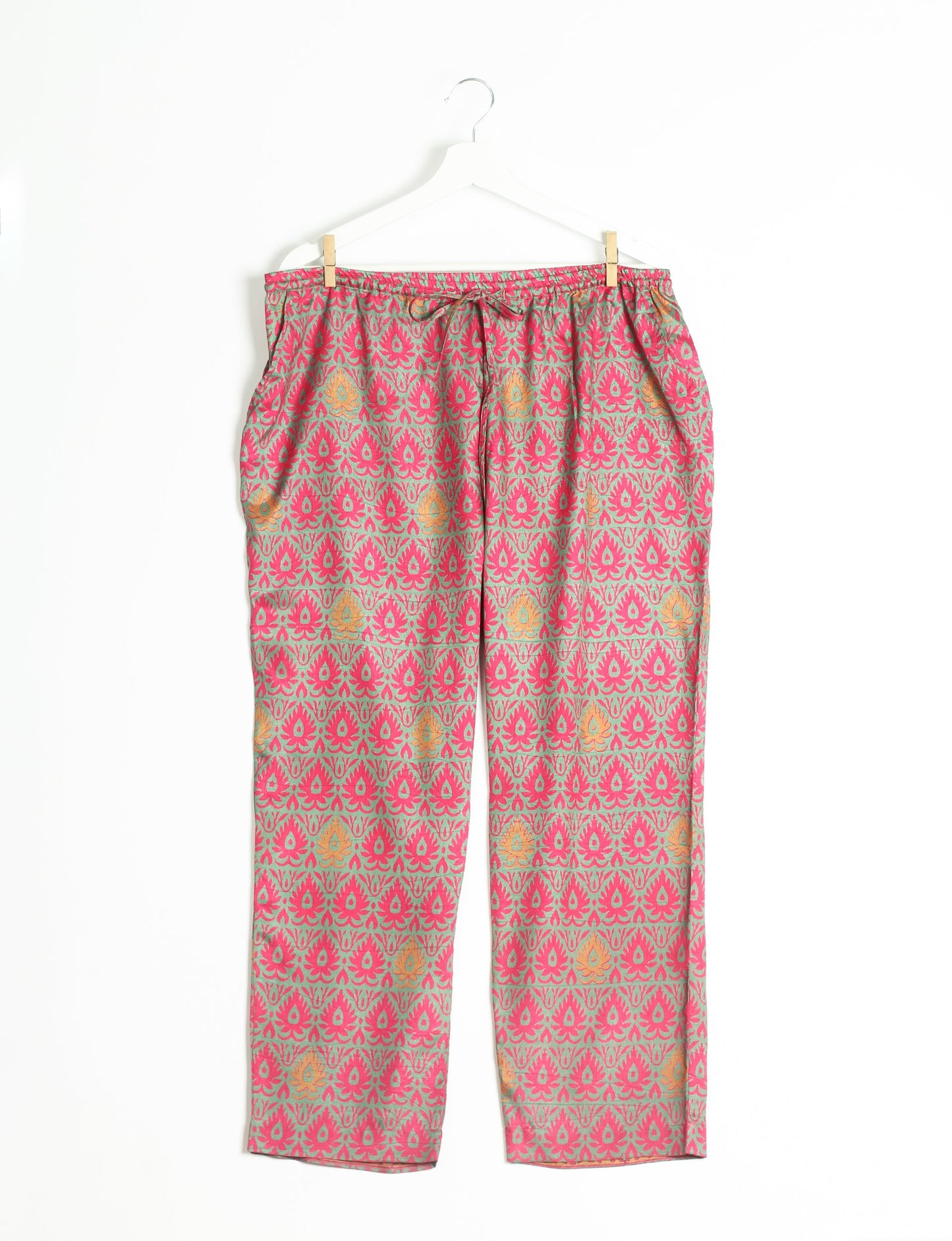 Elevate your wardrobe with our planet-friendly PULL-ON PANTS. Made from upcycled sari fabric, these eco-conscious pants offer a drawstring waist for a perfect fit. Tapered leg design ensures both style and comfort. Choose ethical, green fashion that supports artisans and sustainable living.