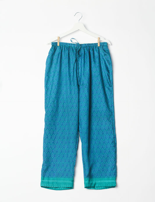 Elevate your wardrobe with our planet-friendly PULL-ON PANTS. Made from upcycled sari fabric, these eco-conscious pants offer a drawstring waist for a perfect fit. Tapered leg design ensures both style and comfort. Choose ethical, green fashion that supports artisans and sustainable living.