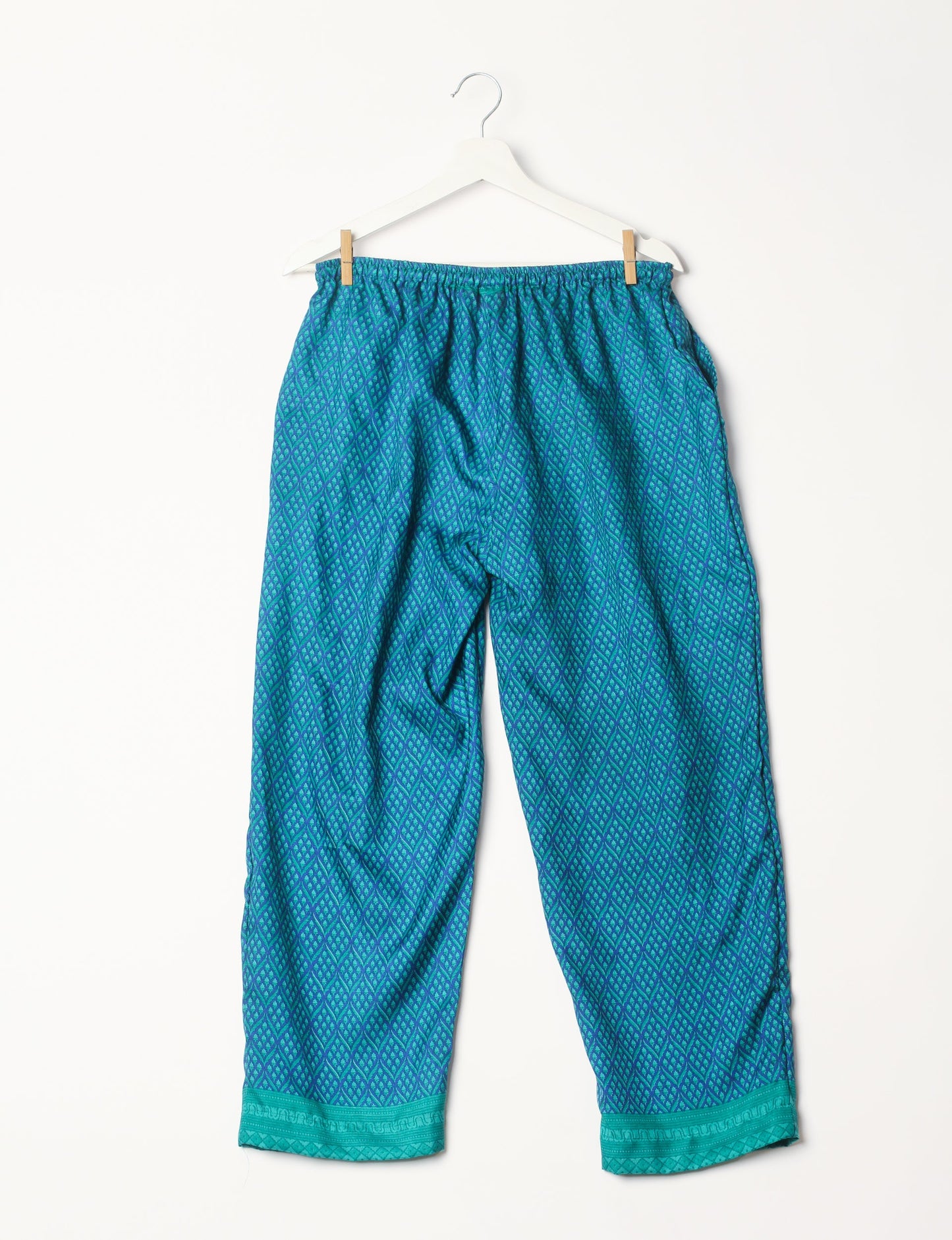 Elevate your wardrobe with our planet-friendly PULL-ON PANTS. Made from upcycled sari fabric, these eco-conscious pants offer a drawstring waist for a perfect fit. Tapered leg design ensures both style and comfort. Choose ethical, green fashion that supports artisans and sustainable living.