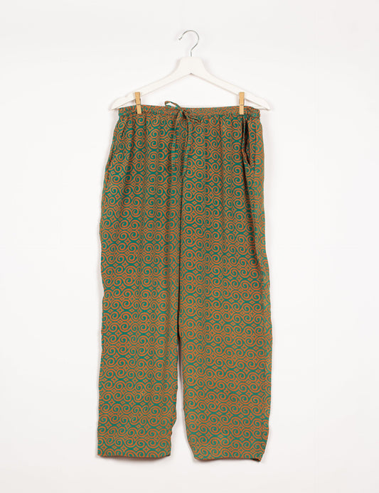 Elevate your wardrobe with our planet-friendly PULL-ON PANTS. Made from upcycled sari fabric, these eco-conscious pants offer a drawstring waist for a perfect fit. Tapered leg design ensures both style and comfort. Choose ethical, green fashion that supports artisans and sustainable living.