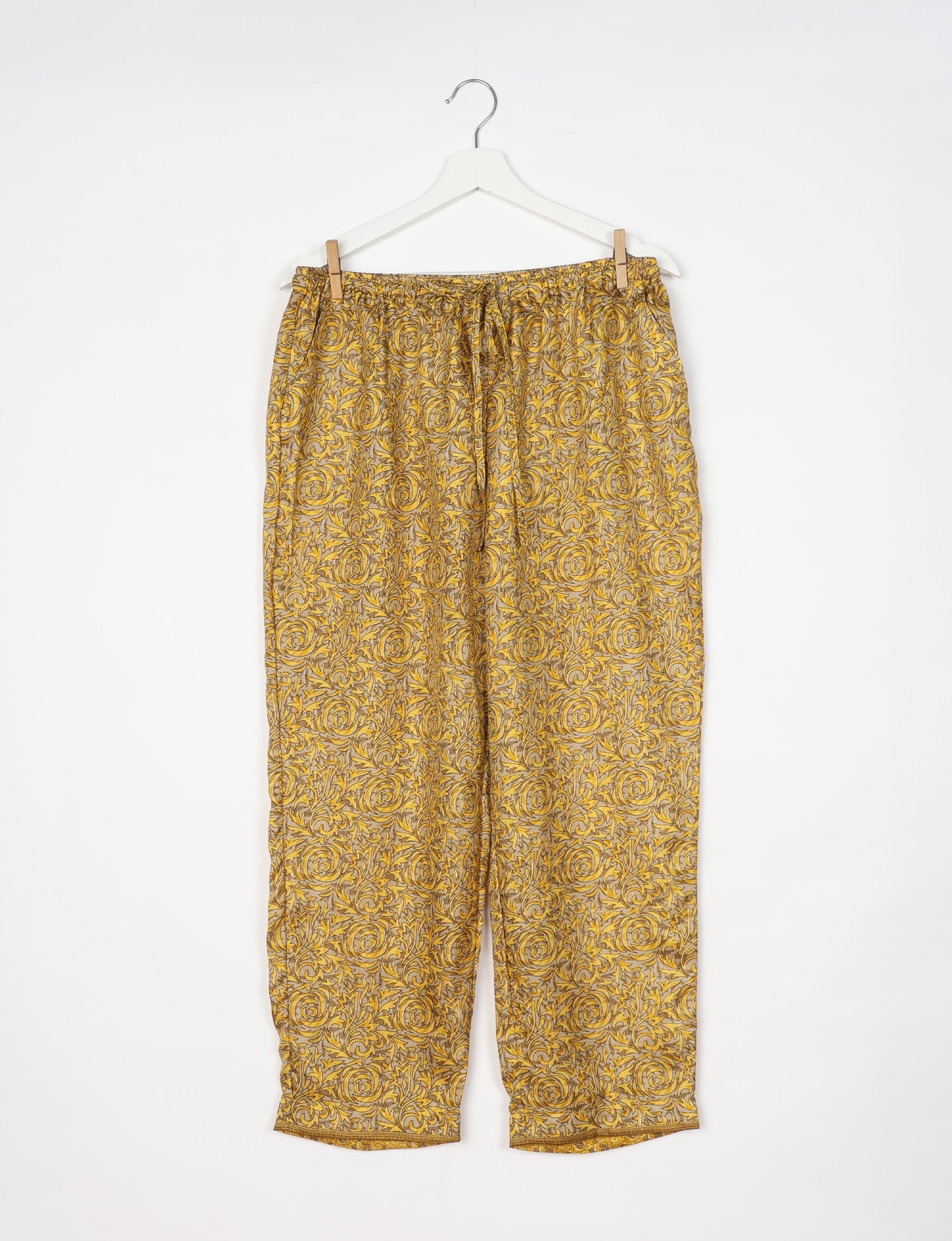 Elevate your wardrobe with our planet-friendly PULL-ON PANTS. Made from upcycled sari fabric, these eco-conscious pants offer a drawstring waist for a perfect fit. Tapered leg design ensures both style and comfort. Choose ethical, green fashion that supports artisans and sustainable living.