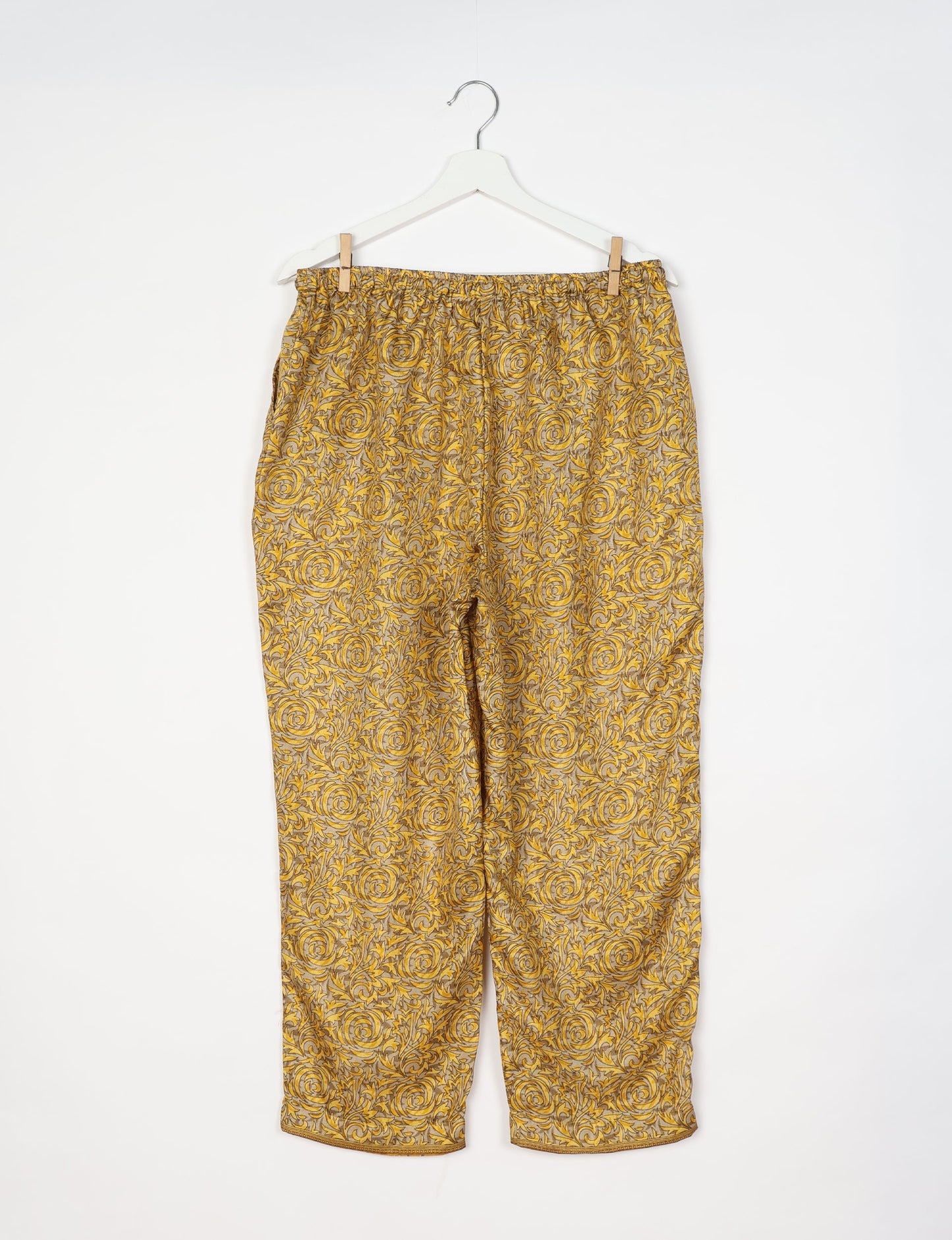 Elevate your wardrobe with our planet-friendly PULL-ON PANTS. Made from upcycled sari fabric, these eco-conscious pants offer a drawstring waist for a perfect fit. Tapered leg design ensures both style and comfort. Choose ethical, green fashion that supports artisans and sustainable living.