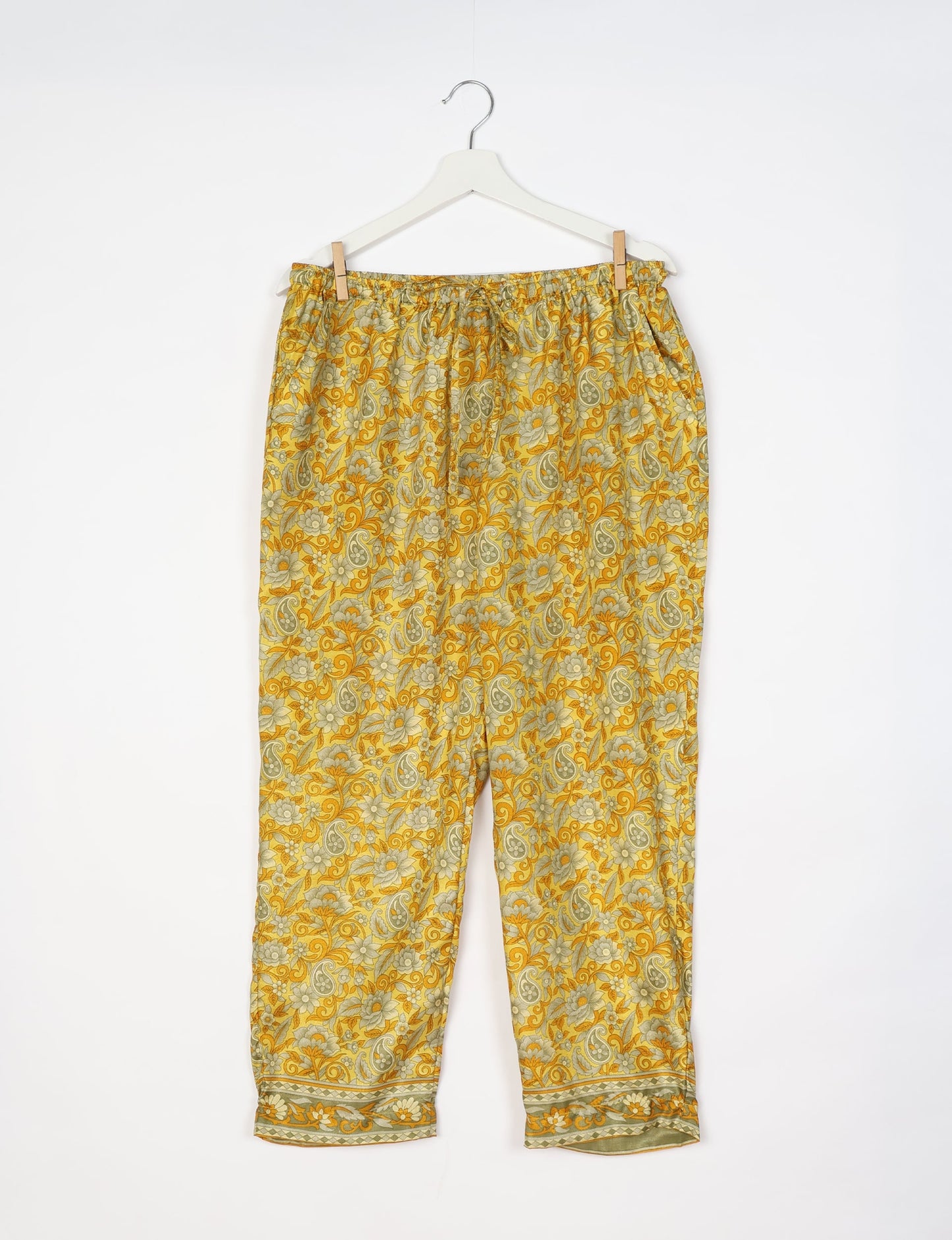 Elevate your wardrobe with our planet-friendly PULL-ON PANTS. Made from upcycled sari fabric, these eco-conscious pants offer a drawstring waist for a perfect fit. Tapered leg design ensures both style and comfort. Choose ethical, green fashion that supports artisans and sustainable living.