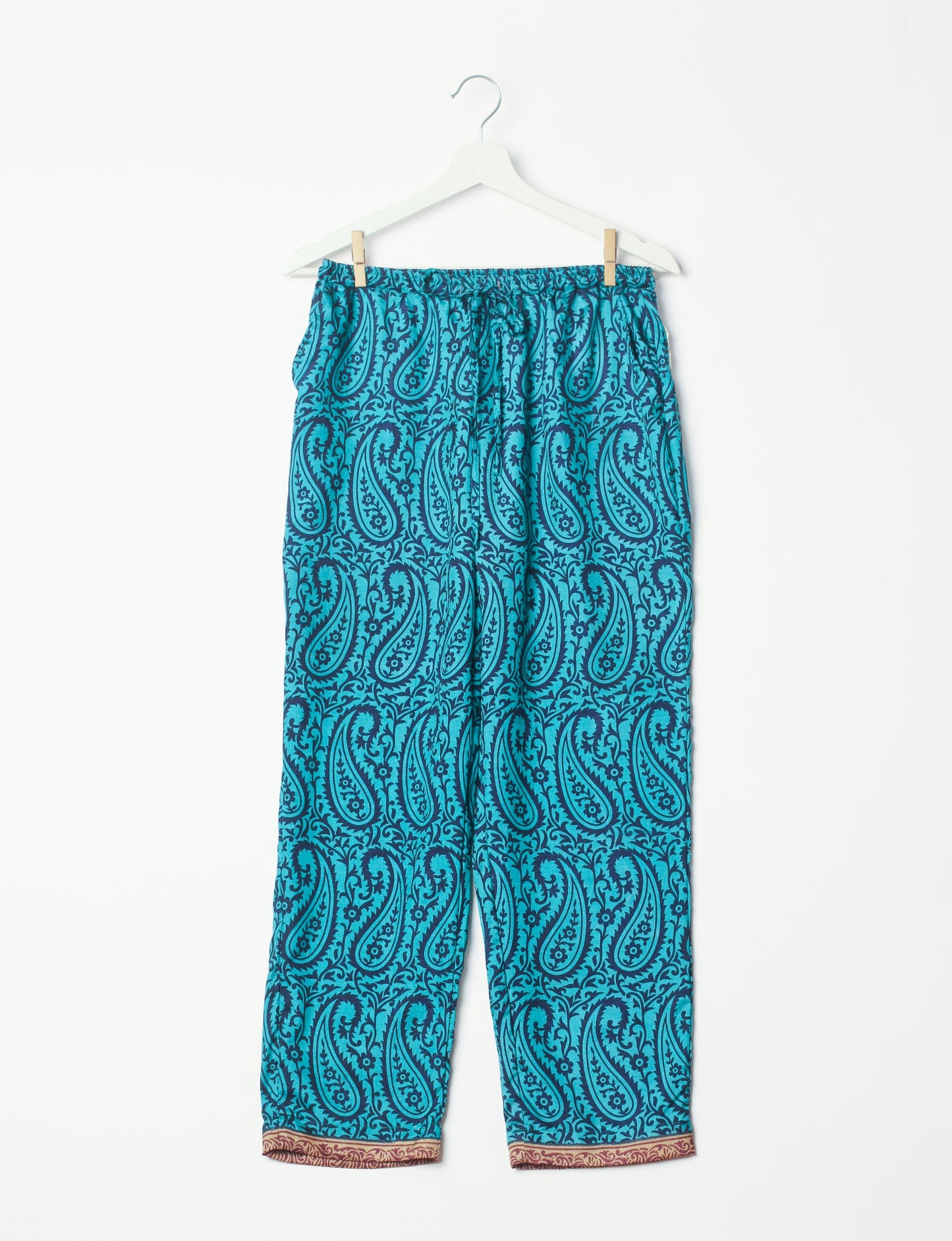 Elevate your wardrobe with our planet-friendly PULL-ON PANTS. Made from upcycled sari fabric, these eco-conscious pants offer a drawstring waist for a perfect fit. Tapered leg design ensures both style and comfort. Choose ethical, green fashion that supports artisans and sustainable living.