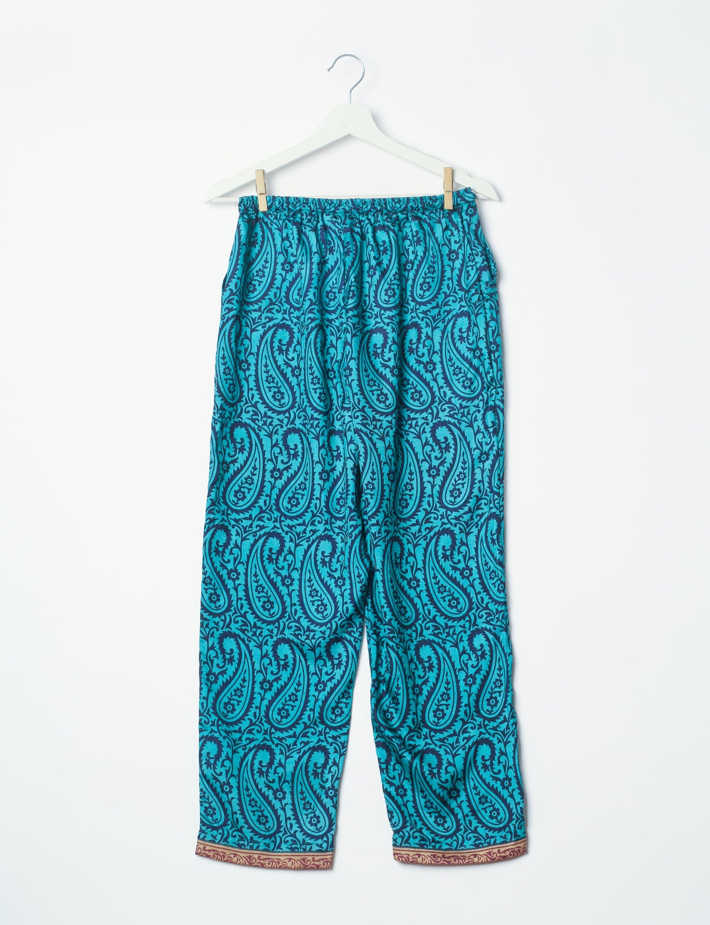 Elevate your wardrobe with our planet-friendly PULL-ON PANTS. Made from upcycled sari fabric, these eco-conscious pants offer a drawstring waist for a perfect fit. Tapered leg design ensures both style and comfort. Choose ethical, green fashion that supports artisans and sustainable living.