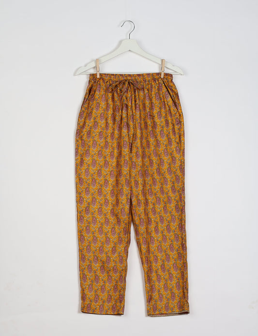 Elevate your wardrobe with our planet-friendly PULL-ON PANTS. Made from upcycled sari fabric, these eco-conscious pants offer a drawstring waist for a perfect fit. Tapered leg design ensures both style and comfort. Choose ethical, green fashion that supports artisans and sustainable living.