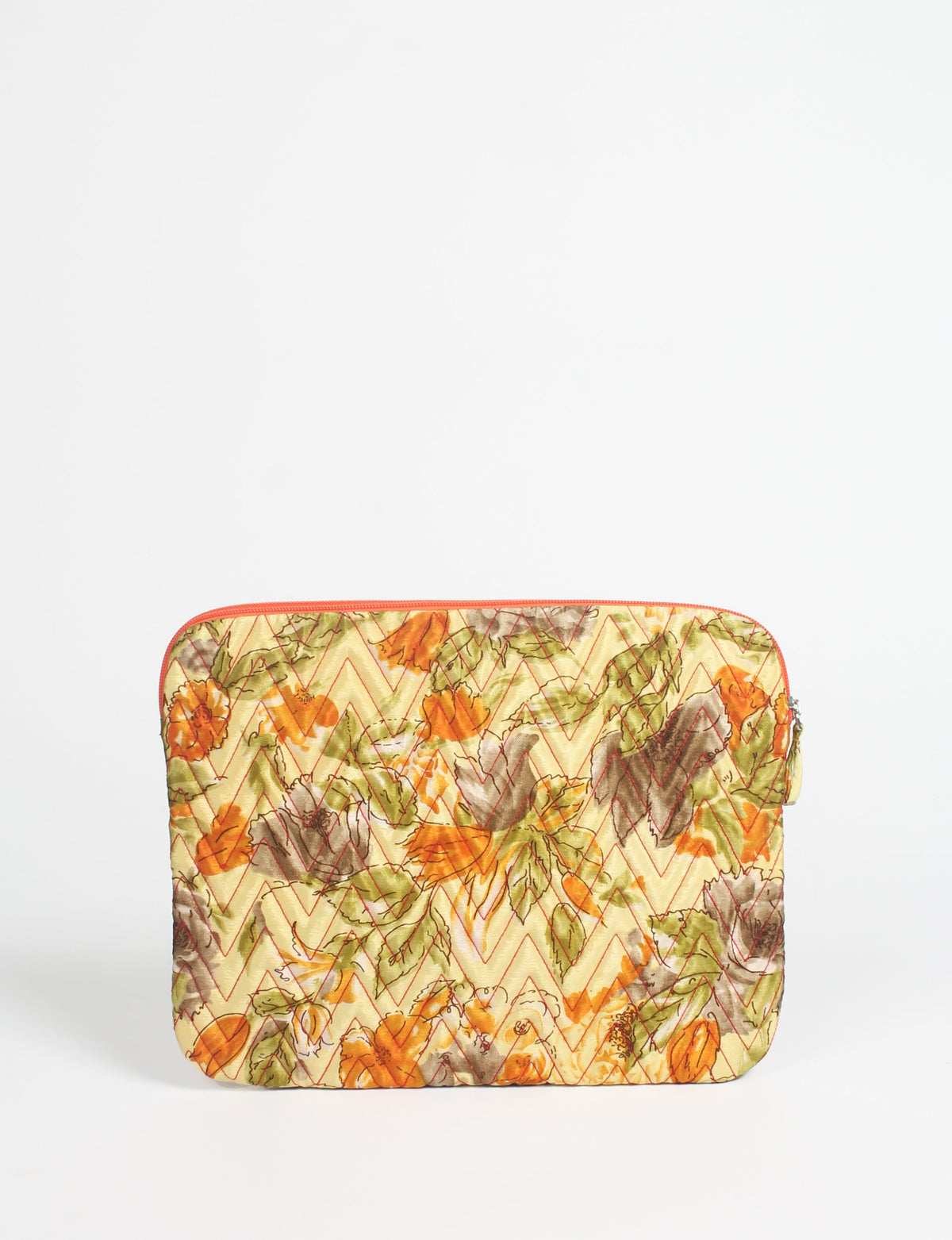 Quilted laptop sleeve with yellow floral pattern, orange zipper, and zigzag stitching, shown flat on white background
