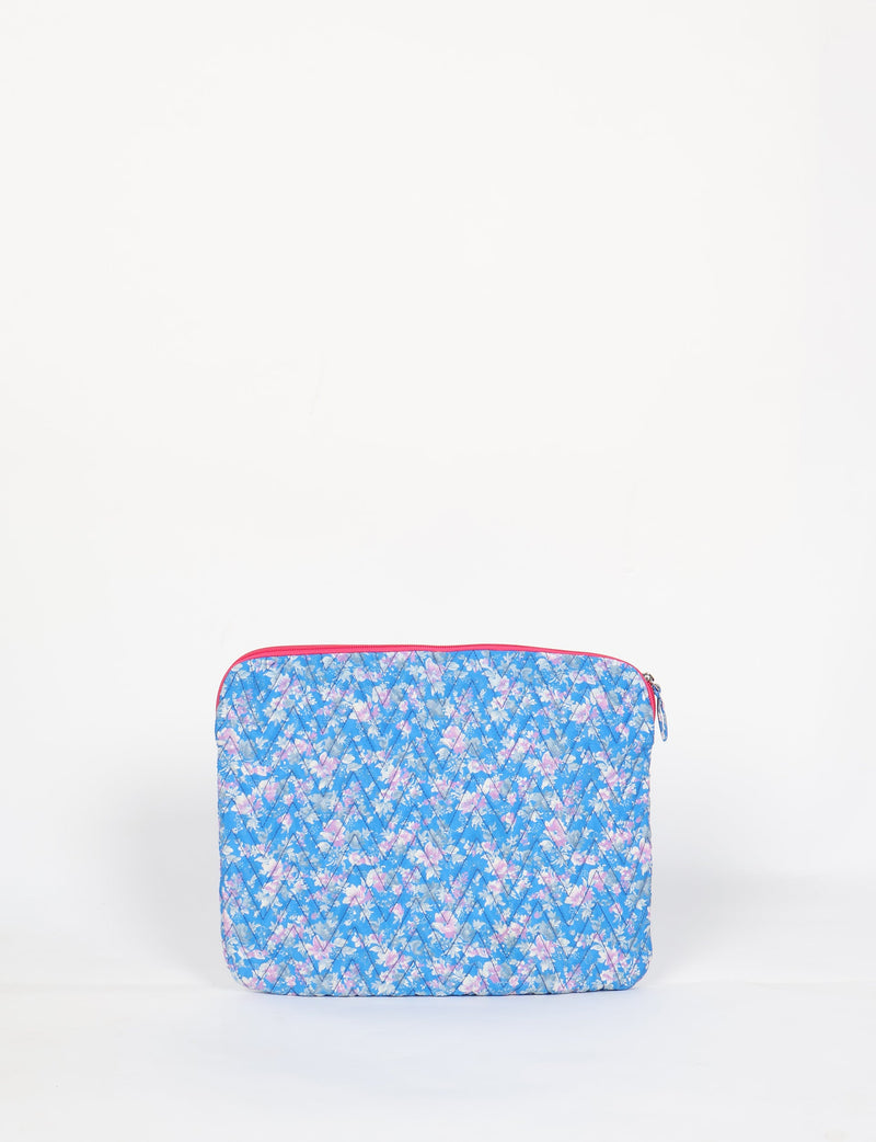 Quilted laptop sleeve with blue floral pattern, pink zipper, and diamond stitching, shown front view on white background