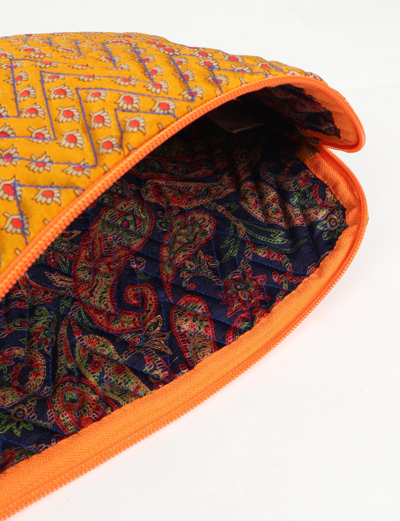 Quilted laptop sleeve with yellow floral micro design exterior and dark multicolor paisley quilted interior, orange zipper edge