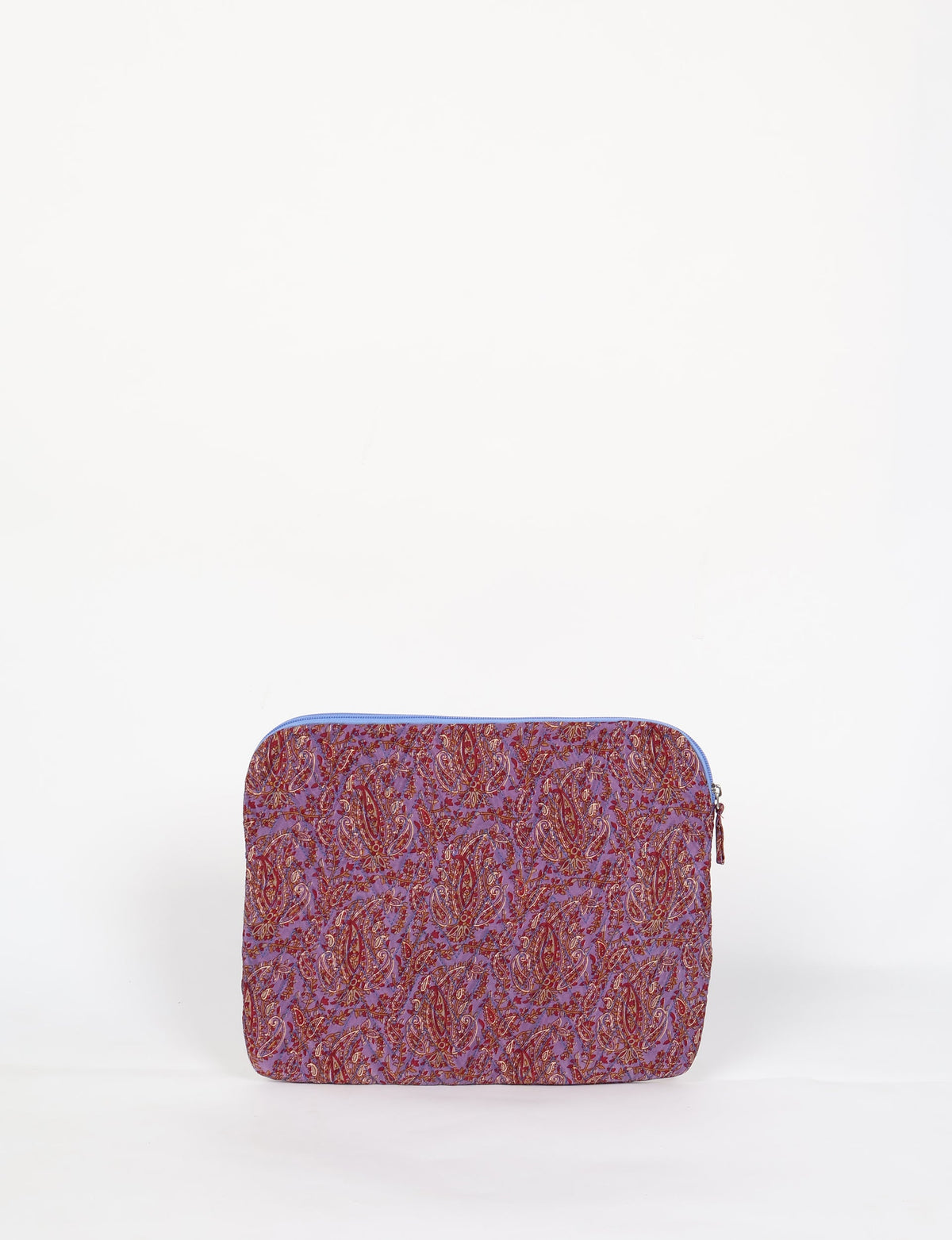 Quilted laptop sleeve with purple paisley pattern, blue zipper, and rounded corners, shown flat on white background