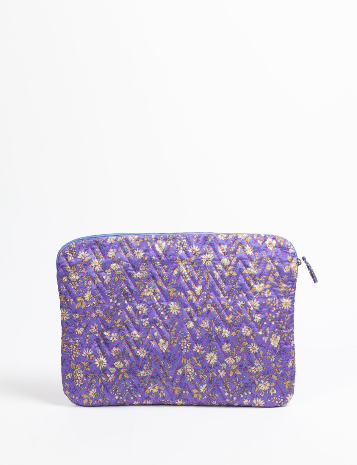Quilted laptop sleeve in purple with floral pattern, zipper closure, and diagonal stitching, flat lay front view