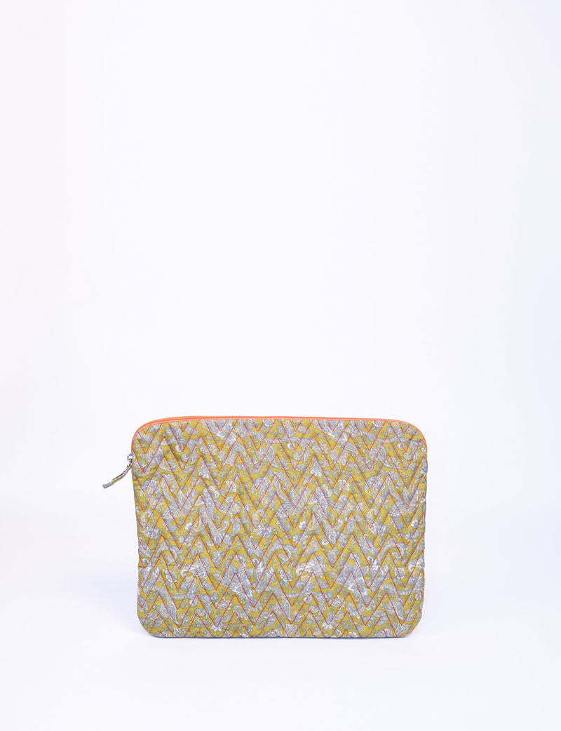 Quilted laptop sleeve in yellow with tropical floral pattern, orange zipper, shown flat against white background