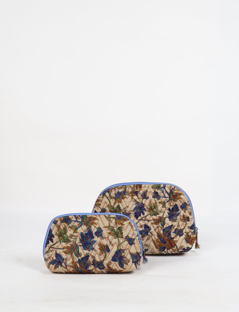 Set of two beige quilted vanity pouches with blue, green, and brown leaf patterns and blue zipper trims, front view