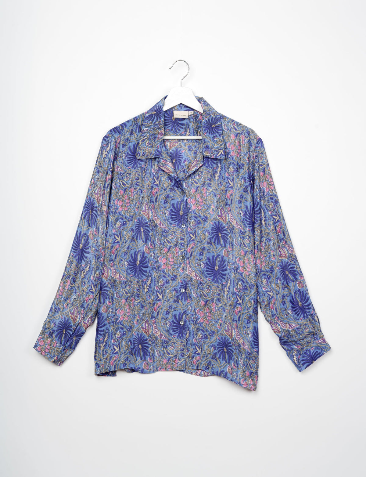 A person wearing a Resort Shirt, a sustainable fashion choice made from recycled materials.