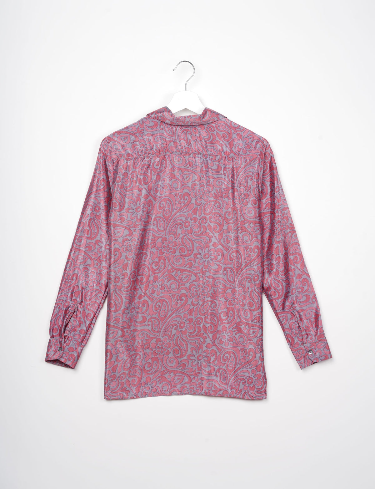 Pink floral patterned long-sleeve resort shirt shown from the back on a white hanger against a white background