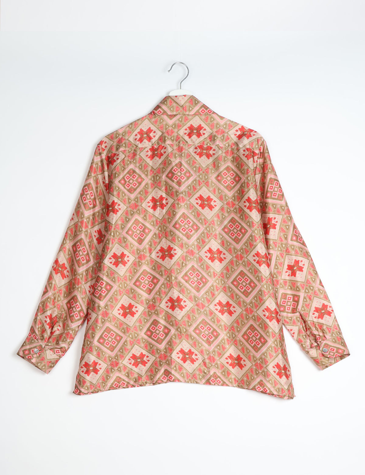 Beige resort shirt with red and pink Indian ethnic diamond and floral patterns, long sleeves, shown from back on hanger