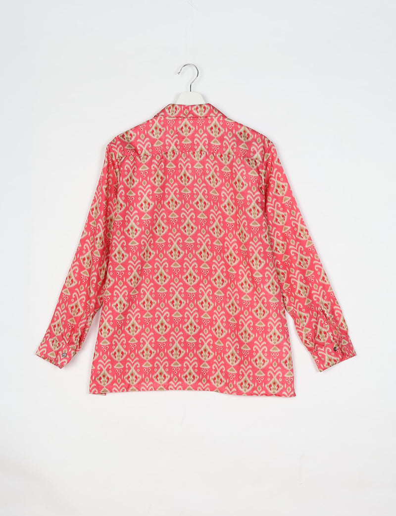Pink resort shirt with Indian ethnic pattern, long sleeves, buttoned cuffs, shown from back on hanger